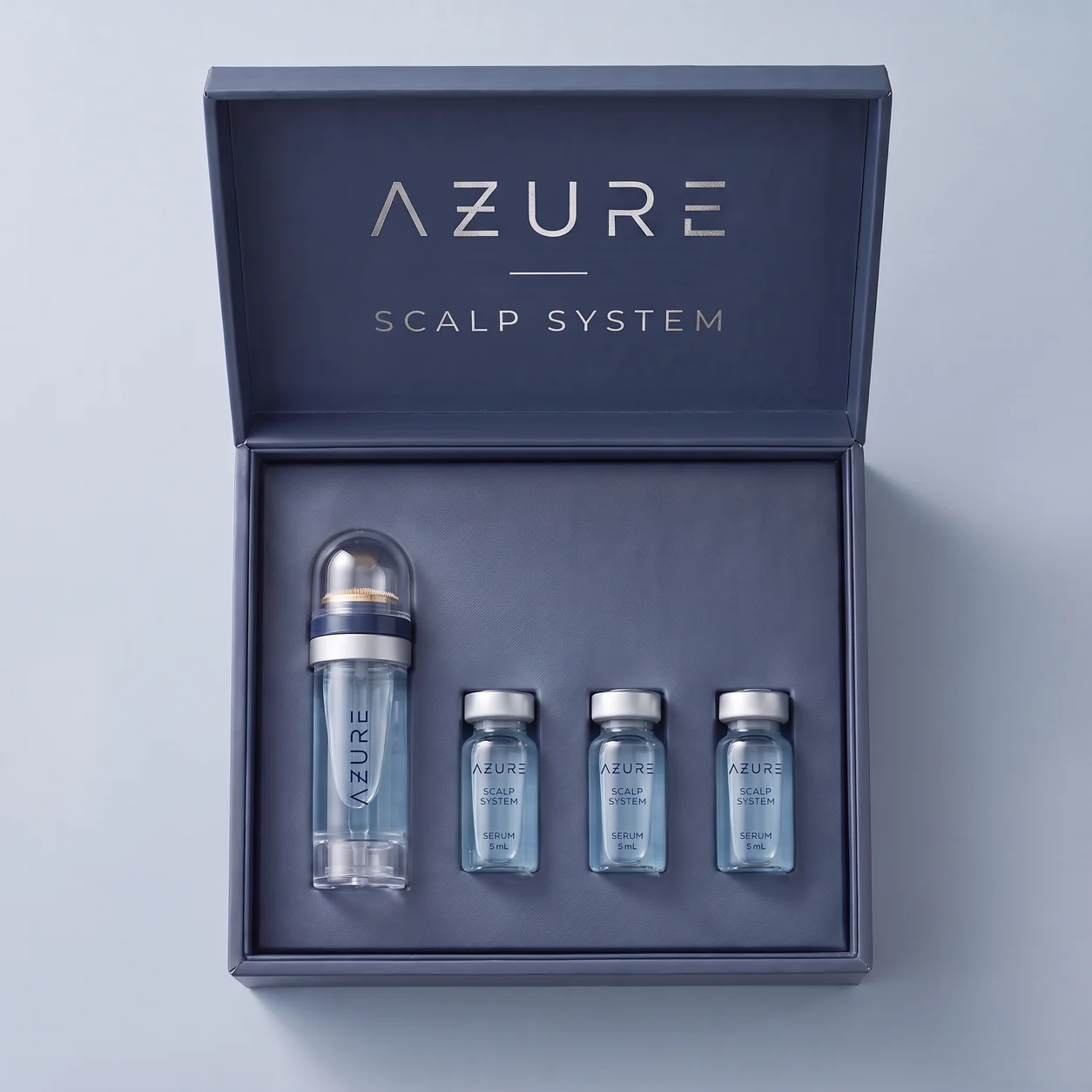 Open navy AZURE presentation box with the applicator and three glass serum vials
